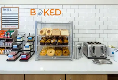a bakery counter with a bunch of donuts on display at Sonesta ES Suites San Diego - Sorrento Mesa in Sorrento