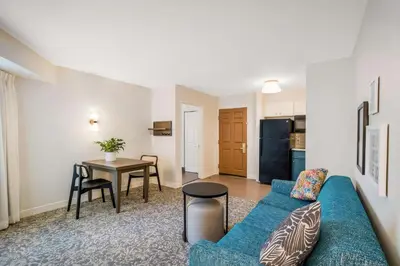 a living room with a blue couch and a table at Sonesta ES Suites San Diego - Sorrento Mesa in Sorrento