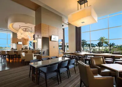 a restaurant with tables and chairs and windows at Hilton San Diego Bayfront in San Diego