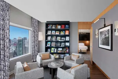a living room with chairs and a book shelf at Hilton San Diego Bayfront in San Diego