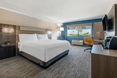 a hotel room with a bed and a television at Holiday Inn Express San Diego South - National City by IHG in National City