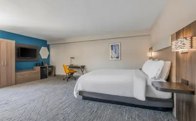 a hotel room with a bed and a desk at Holiday Inn Express San Diego South - National City by IHG in National City