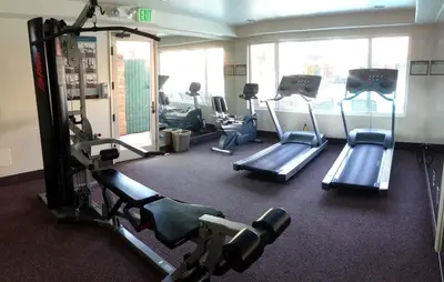 a gym with several tread machines in a room at Laguna Hills Lodge-Irvine Spectrum in Laguna Hills