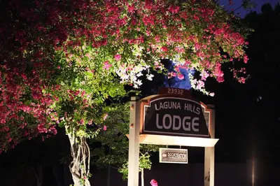a sign in front of a tree with pink flowers at Laguna Hills Lodge-Irvine Spectrum in Laguna Hills
