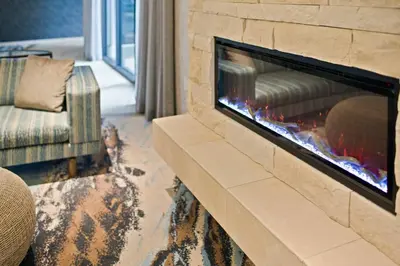 a fireplace in a living room with a couch at Fairfield Inn & Suites by Marriott San Diego Pacific Beach in San Diego