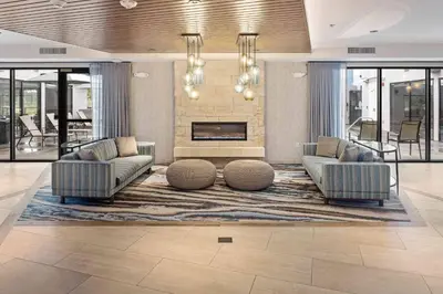 a living room with two couches and a fireplace at Fairfield Inn & Suites by Marriott San Diego Pacific Beach in San Diego