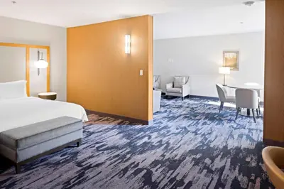 a hotel room with a bed and a table and chairs at Fairfield Inn & Suites by Marriott San Diego Pacific Beach in San Diego