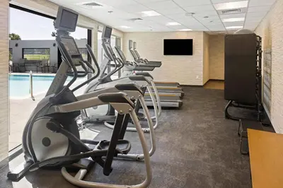 a gym with cardio equipment and a swimming pool at Fairfield Inn & Suites by Marriott San Diego Pacific Beach in San Diego