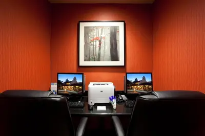 a room with a desk with three computers on it at Holiday Inn Express San Clemente N – Beach Area by IHG in San Clemente