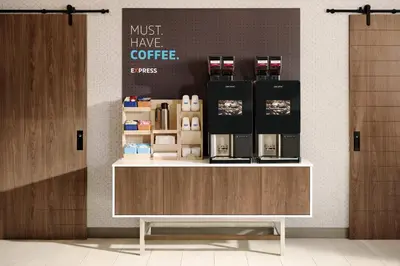 a coffee shop with a counter with a coffee maker at Holiday Inn Express San Clemente N – Beach Area by IHG in San Clemente