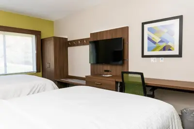 a hotel room with two beds and a desk and a tv at Holiday Inn Express San Clemente N – Beach Area by IHG in San Clemente