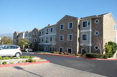 a car parked in a parking lot in front of buildings at Staybridge Suites Irvine East/Lake Forest by IHG in Lake Forest