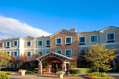 a large brick building with an archway in front of it at Staybridge Suites Irvine East/Lake Forest by IHG in Lake Forest