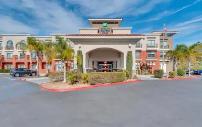 a hotel with a parking lot in front of it at Holiday Inn Express Hotel & Suites Lake Elsinore by IHG in Lake Elsinore
