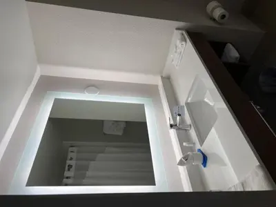 a bathroom with a mirror and a sink in a room at Holiday Inn Express Hotel & Suites Lake Elsinore by IHG in Lake Elsinore