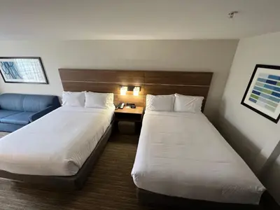 a hotel room with two beds and a couch at Holiday Inn Express Hotel & Suites Lake Elsinore by IHG in Lake Elsinore