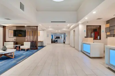 an empty lobby of a hospital with chairs and tables at Holiday Inn Express Hotel & Suites Lake Elsinore by IHG in Lake Elsinore