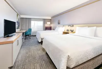a hotel room with two beds and a flat screen tv at Hilton Garden Inn Irvine East/Lake Forest in Foothill Ranch