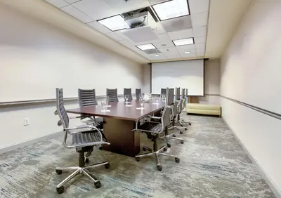 a conference room with a long table and chairs at Hilton Garden Inn Irvine East/Lake Forest in Foothill Ranch