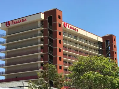 a hotel building with a ramsonian sign on it at Ramada by Wyndham San Diego National City in National City