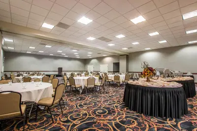 a large banquet room with tables and chairs at Ramada by Wyndham San Diego National City in National City