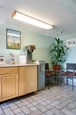 a kitchen with a counter and a table and chairs at Heritage Inn La Mesa in La Mesa