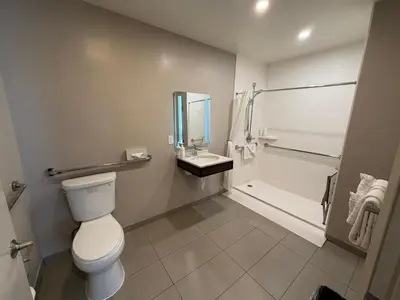 a bathroom with a toilet and a shower and a sink at Heritage Inn San Diego in San Diego
