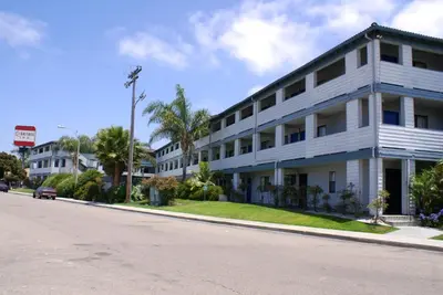 a white building on the side of a street at Heritage Inn San Diego in San Diego
