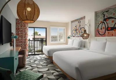 a hotel room with two beds and a balcony at Holiday Inn Express Hotel & Suites Solana Beach-Del Mar by IHG in Solana Beach