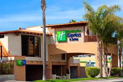 a front view of a hotel with palm trees at Holiday Inn Express Hotel & Suites Solana Beach-Del Mar by IHG in Solana Beach