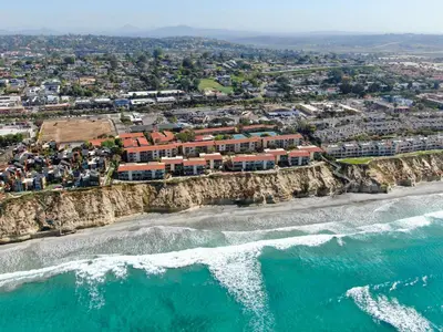 an aerial view of a beach with houses on a cliff at Holiday Inn Express Hotel & Suites Solana Beach-Del Mar by IHG in Solana Beach