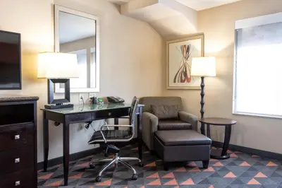 a hotel room with a desk and a chair at Holiday Inn Oceanside Marina Camp Pendleton by IHG in Oceanside