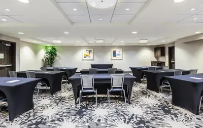 a conference room with black tables and chairs at Holiday Inn Oceanside Marina Camp Pendleton by IHG in Oceanside