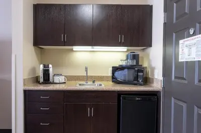 a kitchen with a sink and a microwave at Holiday Inn Oceanside Marina Camp Pendleton by IHG in Oceanside