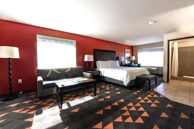 a hotel room with a bed and a couch at Holiday Inn Oceanside Marina Camp Pendleton by IHG in Oceanside
