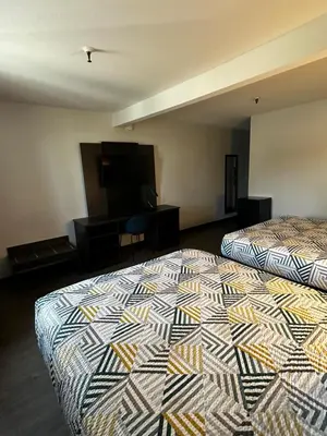 a hotel room with two beds and a flat screen tv at Motel 6-San Diego, CA - Hotel Circle - Mission Valley in San Diego