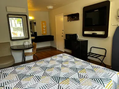 a bedroom with a bed and a flat screen tv at Motel 6-San Diego, CA - Hotel Circle - Mission Valley in San Diego