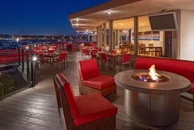 a restaurant with a fire pit on a deck at night at Hyatt Regency Mission Bay Spa and Marina in San Diego
