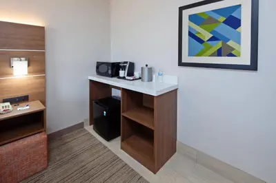 a hotel room with a desk with a microwave at Holiday Inn Express Hotel & Suites San Diego-Escondido by IHG in Escondido