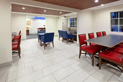 a dining room with red and blue chairs and a table at Holiday Inn Express Hotel & Suites San Diego-Escondido by IHG in Escondido