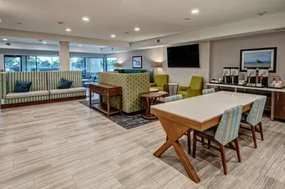 a waiting room with a table and chairs at Hampton by Hilton Encinitas-Cardiff Encinitas, CA near Del Mar in Encinitas