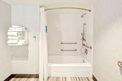 a bathroom with a white tub and a shower at Hampton by Hilton Encinitas-Cardiff Encinitas, CA near Del Mar in Encinitas