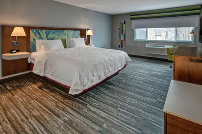 a hotel room with a large bed and a window at Hampton by Hilton Encinitas-Cardiff Encinitas, CA near Del Mar in Encinitas
