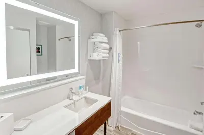 a white bathroom with a sink and a shower at Hampton by Hilton Encinitas-Cardiff Encinitas, CA near Del Mar in Encinitas