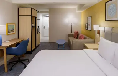a hotel room with a bed and a desk at Hilton Garden Inn Dana Point Doheny Beach in Dana Point