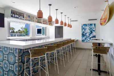 a restaurant with a bar with stools at Hilton Garden Inn Dana Point Doheny Beach in Dana Point