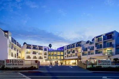 a row of apartment buildings in a parking lot at Hilton Garden Inn Dana Point Doheny Beach in Dana Point