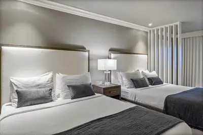 a hotel room with two beds with pillows at The Volare, an Ascend Collection Hotel in San Clemente