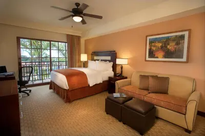 a hotel room with a bed and a couch at Marbrisa Carlsbad Resort in Carlsbad