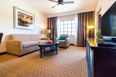 a living room with a couch and a tv at Marbrisa Carlsbad Resort in Carlsbad